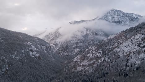 aerial view over snow covered american fork canyon and mountains, utah