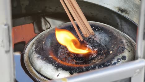 burning incense in a temple oil lamp