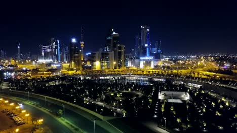 panoramic view of kuwait city at night. modern middle east cityscape nightlife. front dolly aerial shot