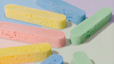colorful pastel sponges on a minimalist background