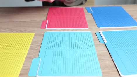 organizing files and folders on a wooden desk