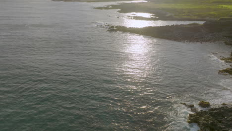 aerial of the pacific ocean meeting the shore at sandy beach park on the island of oahu in hawaii at golden hour