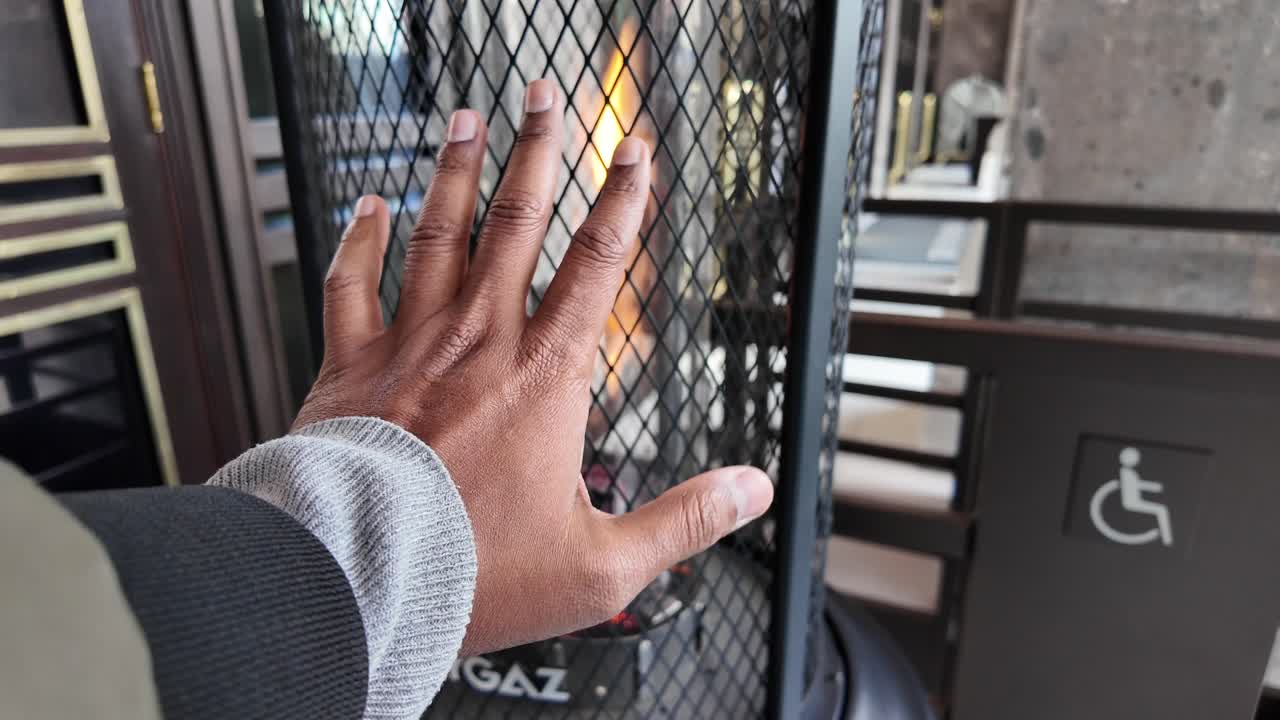 Hand near a gas heater