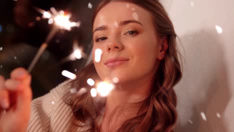 Happy-Young-Woman-Dancing-with-Sparklers.Happy-young-woman-dancing-with-sparklers-near-snowy-pine-trees