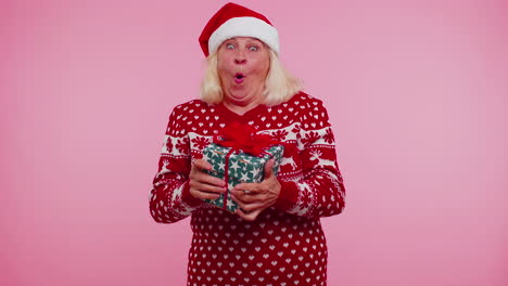 Grandmother-woman-in-sweater-Santa-Christmas-getting-present-gift-box-expressing-amazement-happiness