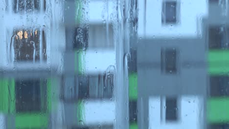 streams of water and raindrops on the window glass