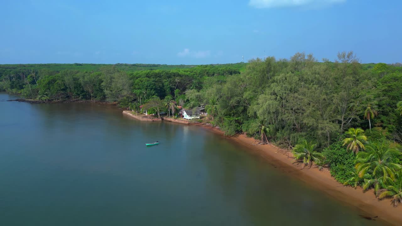 Small fishing boat floating near tropical coast of Koh Mak island, Thailand. Spectacular aerial view flight descending drone
