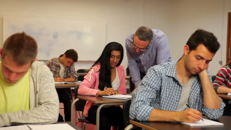 Happy-student-asking-her-teacher-something-in-class