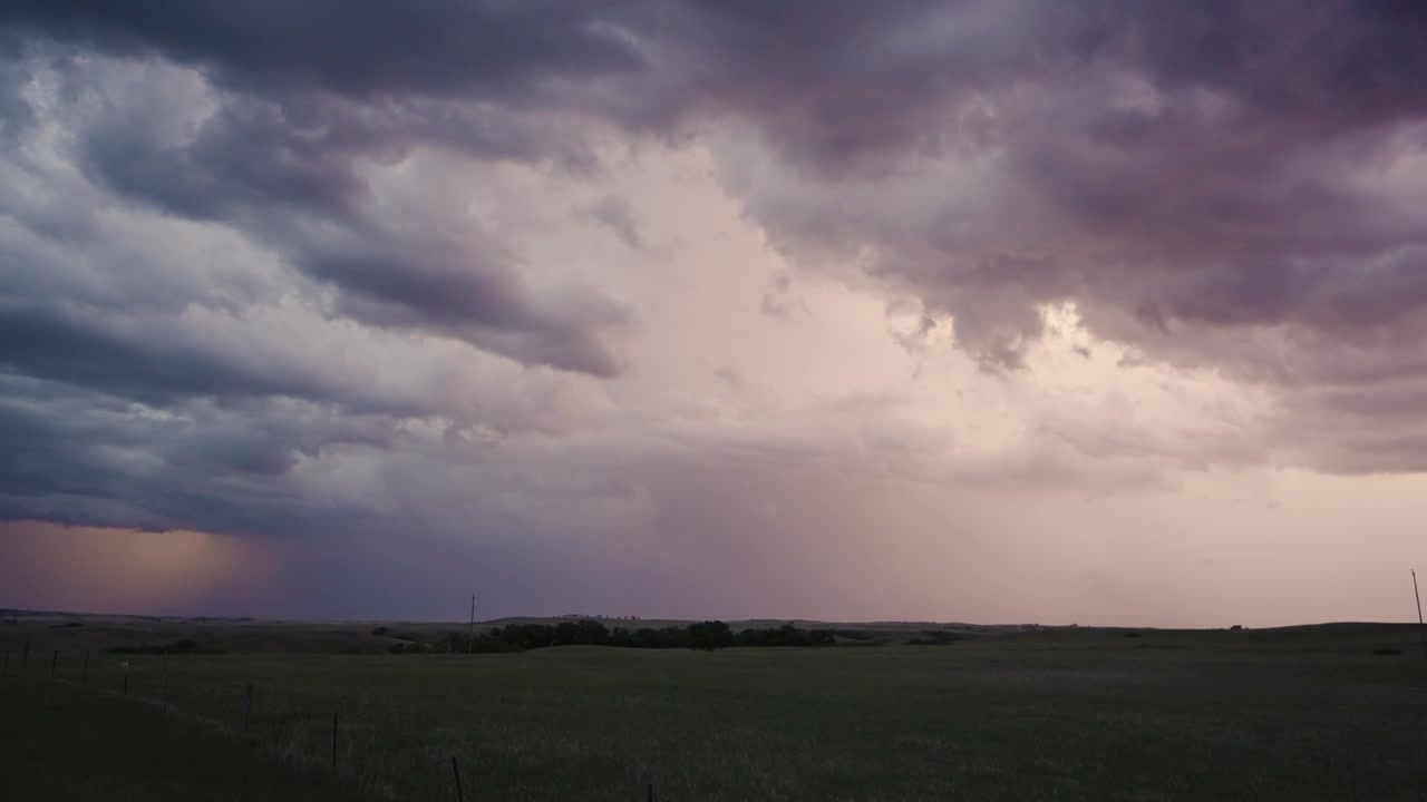 Powerful storm front with flashing lightning in dark clouds
