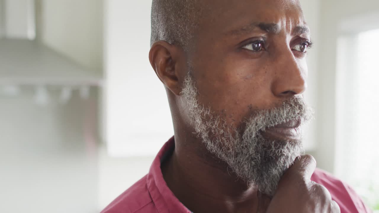 Video of thoughtful african american man looking outside window