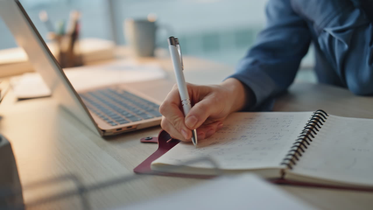 Woman entrepreneur talking smartphone in evening. Closeup hands taking notes