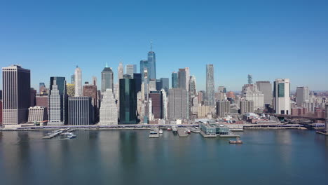 an aerial view over the east east river on a sunny day with blue skies