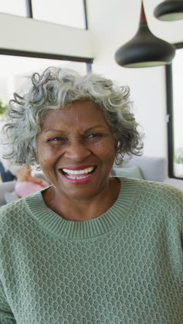 vertical video of happy senior african american woman smiling at camera
