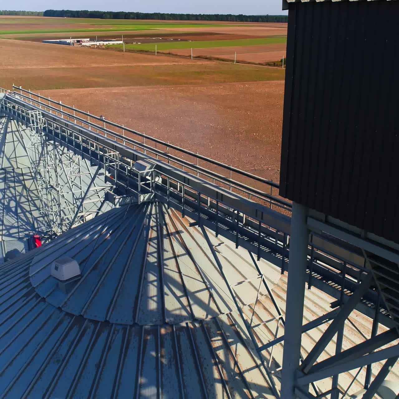 Industrial agriculture elevators with harvested grain. Grain cooperative. Video from copter on roofs