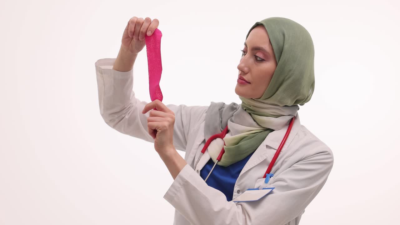 Female Muslim Doctor in Hijab holding a Pink Comb