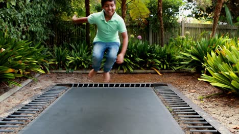 boy jumping up and down on bouncing trampoline 4k