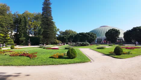 sunny day in porto's jardins do palácio de cristal with people strolling on a peaceful pathway