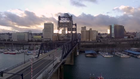 aerial, rising, drone shot overlooking the 11th st bridge, on the thea foss waterway, at sunset, in tacoma wa, usa