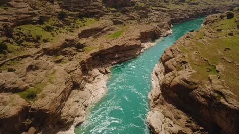 recreation travel enjoy colorful green river in rock cliff clay landscape of natural tourist attraction boat riding in white water canoeing water adventure exciting experience dezful iran countryside