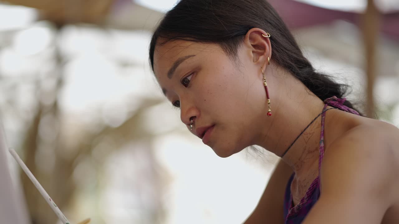 Close-up of a young woman concentrating on her art