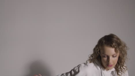 full length studio shot of young woman having fun dancing against grey background 6