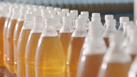 conveyor belt with bottles for juice or water at a modern beverage plant. modern production of sweet soda water