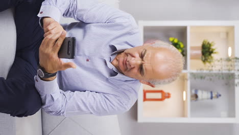 Vertical-video-of-Old-man-texting-on-the-phone-is-arguing-and-tensing.