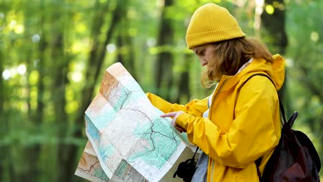 Woman-orientating-with-paper-map-in-forest