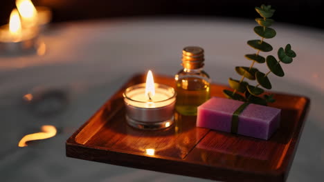 floating spa tray with candles, soap, and eucalyptus