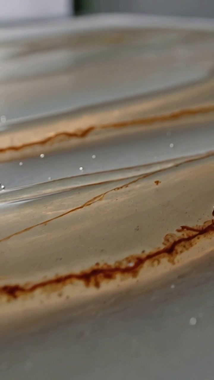 Vertical video: Panning camera showing slab in studio, exposing brown veins, mica flecks for detail
