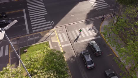 aerial view of juggler performing at zebra crossing during red traffic light