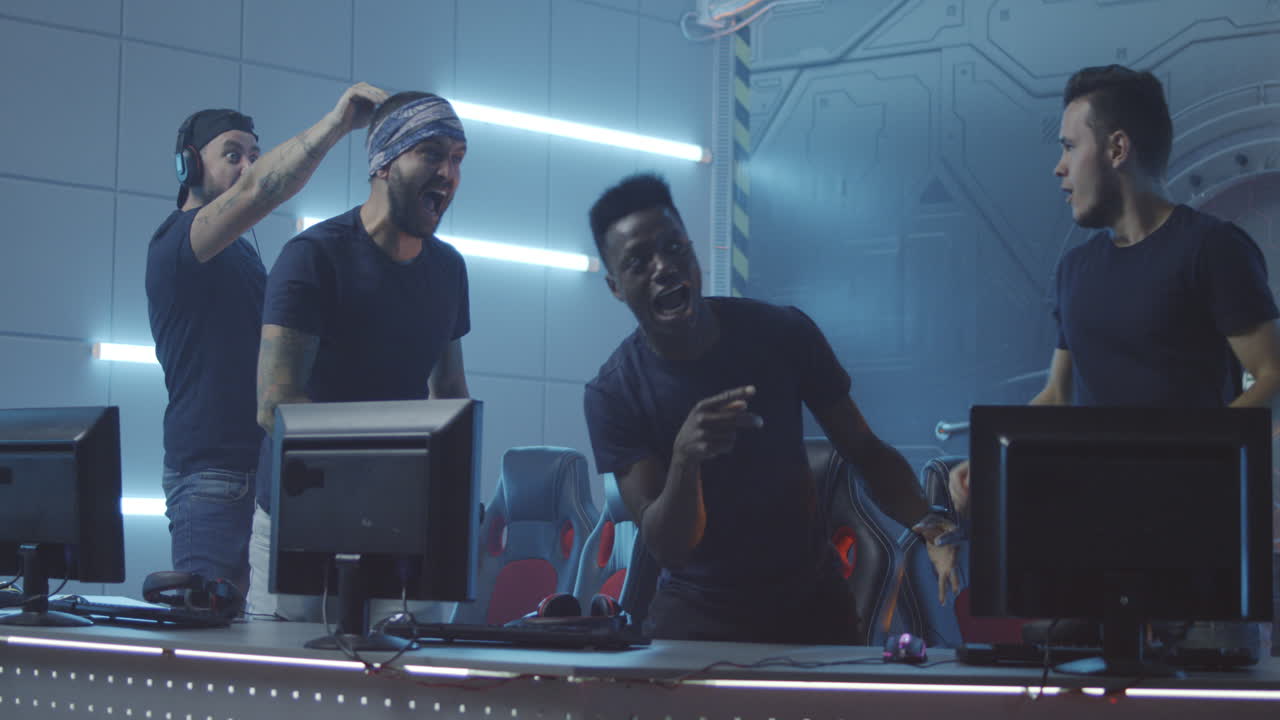 Of Multicultural Female Cybersport Team Winning Game and Cheering Medium Shot of Young Muslim Female Gamer and Asian Teammate Playing in Online Video Game with Tense and Focused Look Winning Match Cheering and Pumping Fists while Celebrating Victory