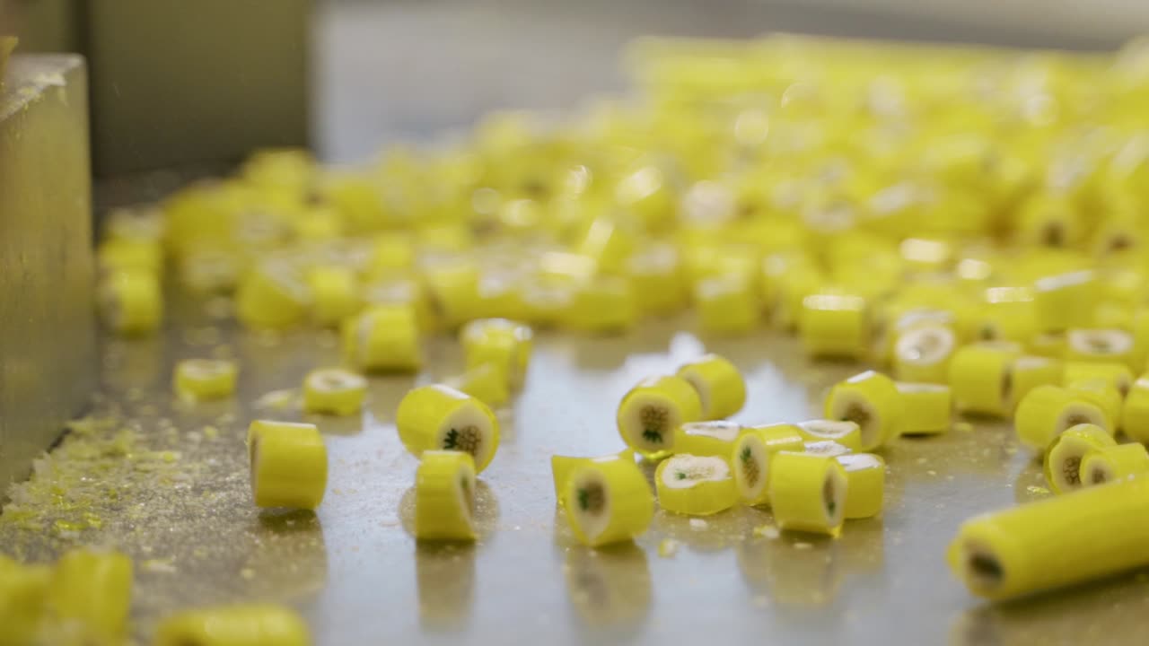 Chopping and cutting caramel candies, slow motion