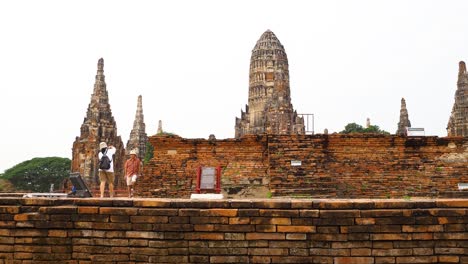 visitors explore ancient temple in ayutthaya, thailand