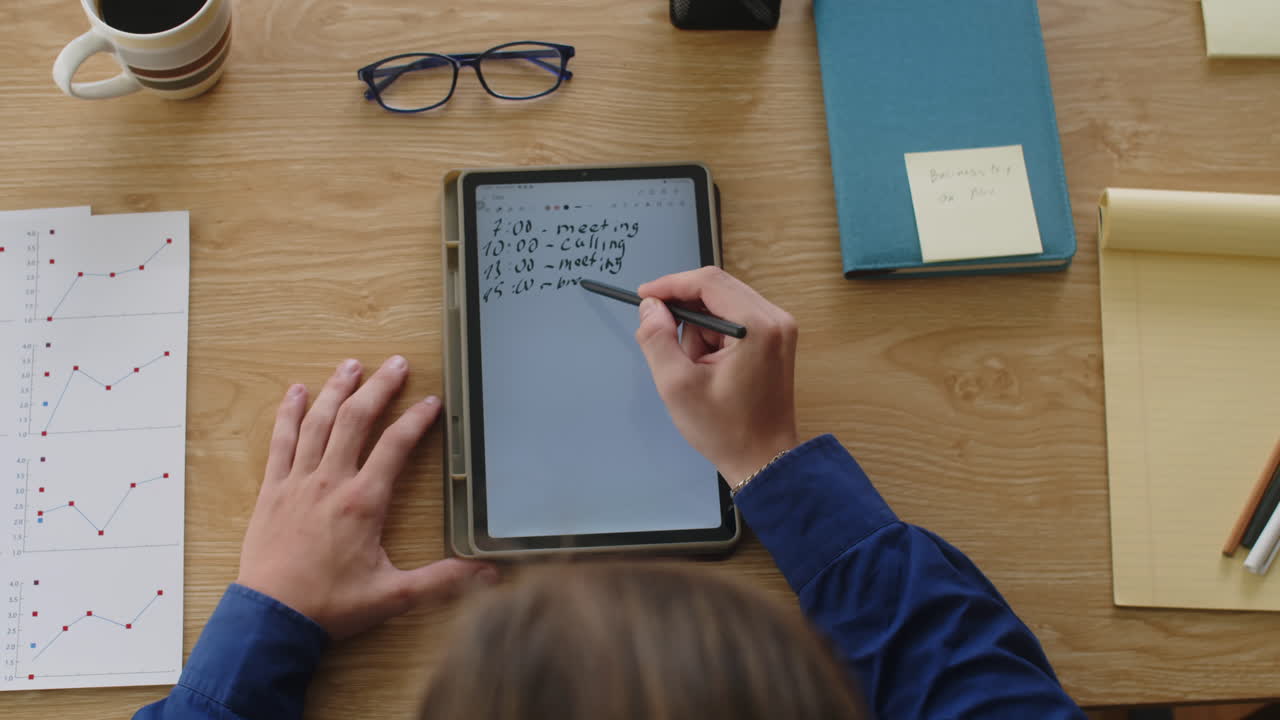 Top View of Entrepreneur Writing Schedule on Tablet at Work