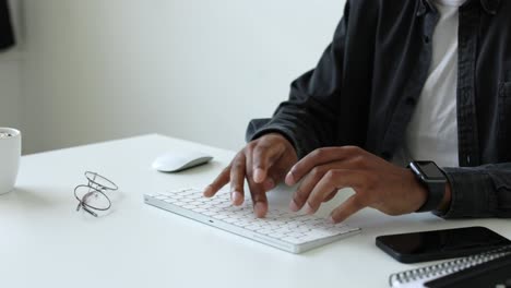 man typing on a computer keyboard