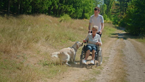 senior woman in wheelchair with a dog and companion