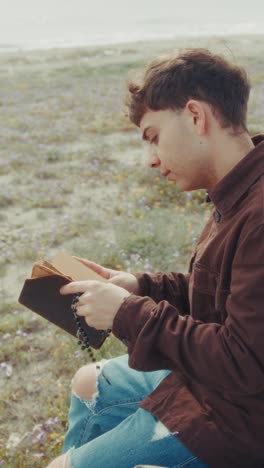 religious man on the beach feeling the devotion to god