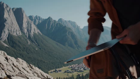 person opening backpack with a scenic mountain valley view