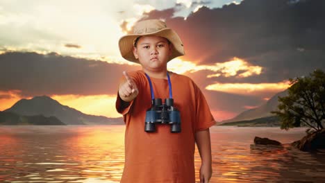 asian boy with a hat and binoculars pointing his finger towards you and shaking head waving index finger avoid offer at a lake. boy researcher showing no gesture