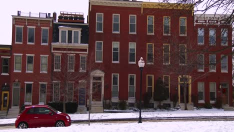 rowhouses line the streets of baltimore maryland in the snow 1