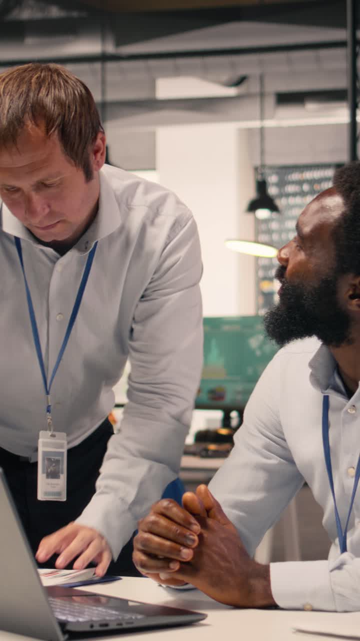 Vertical Video Diverse corporate office scene with team collaboration around laptop