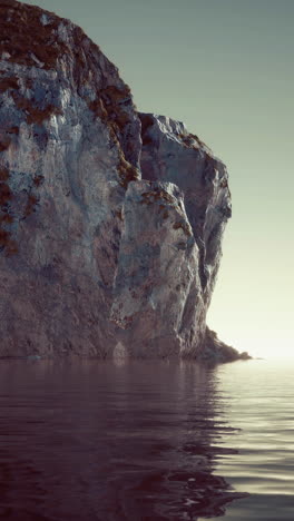 a cliff overlooking the ocean at sunrise