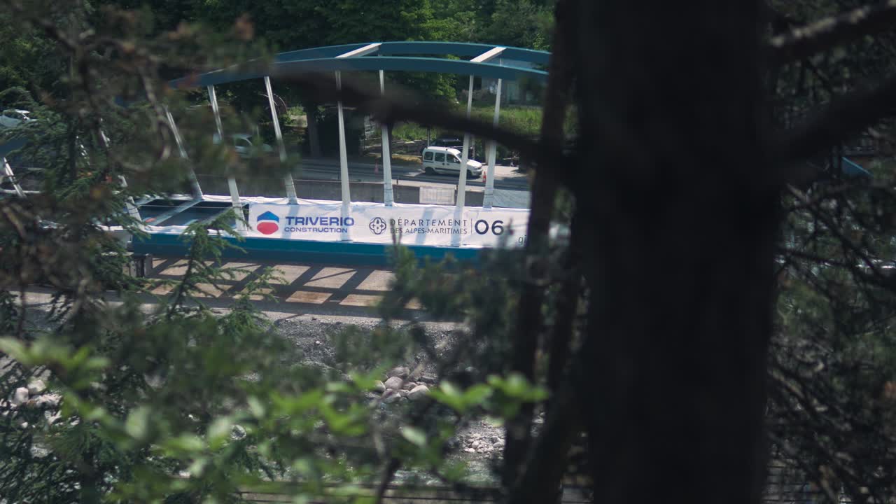 Bridge construction site with rigging, set in a lush forested area in Tende, Breil-sur-Roya