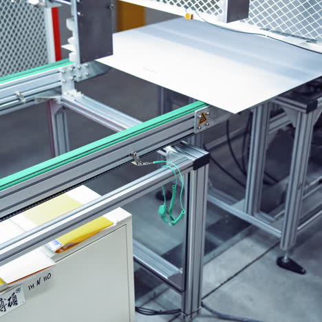 automated equipment at working process. robotic production of a new detail on conveyor on the modern factory background.