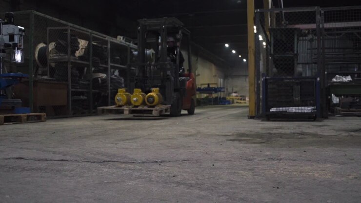 Forklift carrying motors in a warehouse