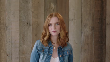 young stylish red head portrait of beautiful woman looking at camera pensive calm wearing denim jacket