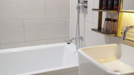 bathroom of a luxury hotel with washbasin and bathtub