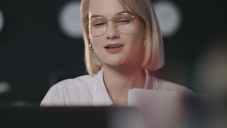 beautiful business woman working on laptop computer in dark office.