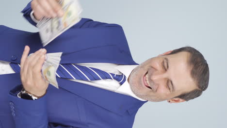 Vertical-video-of-Rich-businessman-counting-money.